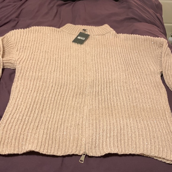 It’s a beautiful sweater with sequins in a beige color. - Picture 2 of 7